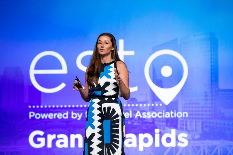 Danielle Posa speaking on stage at ESTO